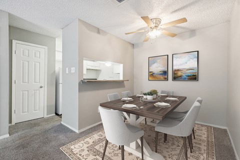 A dining room with a table set for six.